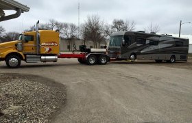 Bock's Service tow truck towing a large RV