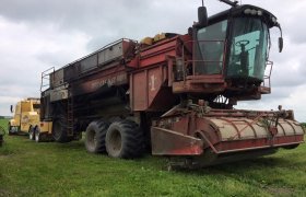 Bock's Service heavy-duty tow truck pulling a combine