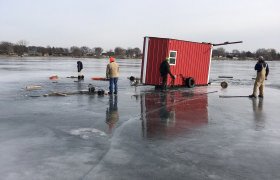 Bock's Service called to a lake to recover a fish house that is falling through the ice